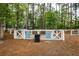 Dog park with a large and small dog area separated by a white fence with dog park rules posted at 107 Clear Bend Ln, Summerville, SC 29486