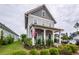 Charming two-story home with gray siding, inviting front porch, and manicured landscaping at 107 Clear Bend Ln, Summerville, SC 29486