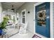 Inviting front porch with rocking chairs, ceiling fan, and charming decor at 107 Clear Bend Ln, Summerville, SC 29486