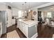 Bright kitchen boasts a spacious island, stainless steel appliances, and hardwood floors at 107 Clear Bend Ln, Summerville, SC 29486