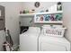 Organized laundry room with shelving, cleaning supplies, washer, and dryer at 107 Clear Bend Ln, Summerville, SC 29486