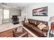 Relaxing living room features a leather sofa, ottoman, decorative rug and plenty of natural light at 107 Clear Bend Ln, Summerville, SC 29486
