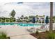 Large community pool with lounge chairs, umbrellas, and beautifully landscaped surroundings at 107 Clear Bend Ln, Summerville, SC 29486
