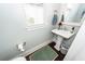 Cozy powder room with pedestal sink, decorative mirror, and neutral color palette at 107 Clear Bend Ln, Summerville, SC 29486