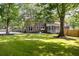 Spacious brick home with a large, grassy yard, a pool, and a screened-in porch at 108 Old Dominion Dr, North Charleston, SC 29418