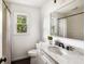 Well lit bathroom featuring hardwood floors, granite countertops and updated fixtures at 108 Old Dominion Dr, North Charleston, SC 29418