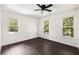 Spacious bedroom with three windows providing lots of natural light and hardwood floors at 108 Old Dominion Dr, North Charleston, SC 29418