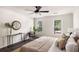 Cozy bedroom with wood floors, ceiling fan, sitting area and natural light from multiple windows at 108 Old Dominion Dr, North Charleston, SC 29418