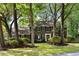Traditional brick home with black shutters and mature trees in a lush green front yard at 108 Old Dominion Dr, North Charleston, SC 29418
