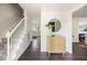 Bright foyer with wood floors, white staircase, and stylish cabinet with decor at 108 Old Dominion Dr, North Charleston, SC 29418