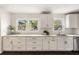 Bright kitchen with white cabinetry, granite countertops, and stainless steel appliances and large windows at 108 Old Dominion Dr, North Charleston, SC 29418