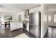 An airy kitchen featuring stainless steel appliances, ample white cabinetry, and a granite countertop island at 108 Old Dominion Dr, North Charleston, SC 29418