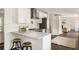 Bright kitchen featuring white cabinets, stainless steel appliances and a granite countertop with bar seating at 108 Old Dominion Dr, North Charleston, SC 29418