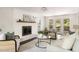 Bright living room featuring a brick fireplace, neutral furniture, and doors to a screened porch at 108 Old Dominion Dr, North Charleston, SC 29418
