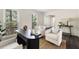 Cozy office area with dark desk, comfy chairs, jute rug, and natural light at 108 Old Dominion Dr, North Charleston, SC 29418