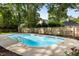 Backyard pool with metal railings and surrounding tall trees and wood fence at 108 Old Dominion Dr, North Charleston, SC 29418