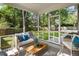 Covered porch with wicker furniture, ceiling fan, striped rug, and view of landscaped yard with a pool at 108 Old Dominion Dr, North Charleston, SC 29418
