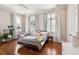 Bright, airy bedroom featuring hardwood floors and multiple windows for natural light at 11 Franklin St, Charleston, SC 29401