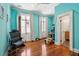Bright bedroom with hardwood floors, colorful walls, large windows, and adjoining bathroom entrance at 11 Franklin St, Charleston, SC 29401
