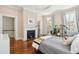 Comfortable bedroom featuring fireplace, hardwood floors and multiple windows at 11 Franklin St, Charleston, SC 29401