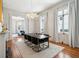 Chandelier-lit dining room features dark wood table set, neutral rug, and access to other living areas at 11 Franklin St, Charleston, SC 29401