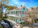 Charming two-story home with a light blue exterior, double porches, and well-maintained landscaping at 11 Franklin St, Charleston, SC 29401
