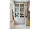 Stylish kitchen featuring glass-front cabinets, exposed brick, and modern appliances at 11 Franklin St, Charleston, SC 29401