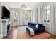 Living room featuring fireplace, large windows, and blue couch at 11 Franklin St, Charleston, SC 29401