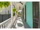 Inviting covered porch featuring ceiling fans, lush greenery, and tranquil outdoor seating area at 11 Franklin St, Charleston, SC 29401