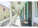 Wide covered porch offers ample seating, ceiling fans, and serene views of the surrounding neighborhood at 11 Franklin St, Charleston, SC 29401