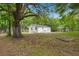 A white house is situated amongst green trees with a fire pit at 1109 Hillside Dr, Charleston, SC 29407