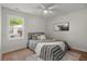 Cozy bedroom with a decorative painting, hardwood floors, a ceiling fan and natural lighting at 1109 Hillside Dr, Charleston, SC 29407