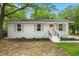 Charming brick home with white trim, a pink door, and a neatly landscaped front yard at 1109 Hillside Dr, Charleston, SC 29407