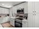 Well-lit kitchen showcasing stainless steel appliances, white cabinetry, and stone countertops at 1109 Hillside Dr, Charleston, SC 29407