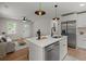 Open concept kitchen with a marble island, stainless steel appliances, and modern pendant lighting at 1109 Hillside Dr, Charleston, SC 29407