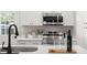 Bright kitchen featuring white cabinetry, stainless steel appliances, and a stylish black faucet at 1109 Hillside Dr, Charleston, SC 29407