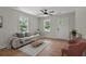 Bright living room featuring fresh paint, hardwood floors, a modern ceiling fan, and new furniture at 1109 Hillside Dr, Charleston, SC 29407