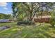Spacious backyard with mature tree coverage and large open green space, perfect for outdoor activities at 113 Harvey Ave, Goose Creek, SC 29445