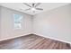 Minimalist bedroom featuring wood floors and natural light from a large window at 113 Harvey Ave, Goose Creek, SC 29445