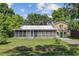 Charming single-story home with a large screened-in porch and landscaped front yard at 113 Harvey Ave, Goose Creek, SC 29445