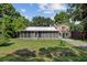 Charming home features a screened-in porch and well-maintained front yard at 113 Harvey Ave, Goose Creek, SC 29445