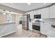 Open kitchen with white cabinets, stainless steel appliances, and an inviting breakfast bar at 113 Harvey Ave, Goose Creek, SC 29445