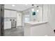 Modern kitchen with white cabinets, stainless steel appliances, and stylish pendant lights at 113 Harvey Ave, Goose Creek, SC 29445