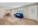 Bright living room featuring hardwood floors, a blue couch, and large windows at 113 Harvey Ave, Goose Creek, SC 29445