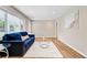 Bright living room featuring a large window, a plush blue sofa, and stylish decor at 113 Harvey Ave, Goose Creek, SC 29445