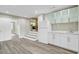 Open floor plan showcasing a living room with new laminate flooring, a kitchen area, and steps leading up at 113 Harvey Ave, Goose Creek, SC 29445