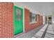 Covered front porch featuring red brick and a vibrant green door at 113 Harvey Ave, Goose Creek, SC 29445