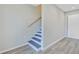 View of a neutral interior with a laminate wood floor, and stairway to the next level at 113 Harvey Ave, Goose Creek, SC 29445