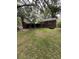 Backyard view of a home featuring a brick exterior, chimney, and covered patio at 1130 Yeamans Hall Rd, Hanahan, SC 29410