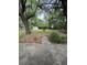 Large backyard surrounded by mature trees, green grass, and foliage at 1130 Yeamans Hall Rd, Hanahan, SC 29410
